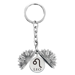 Detail of sunflower locket keychain with Leo zodiac sign engraving on silver metal