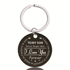 Detail of round black stainless steel keychain with laser engraved inspirational text for son