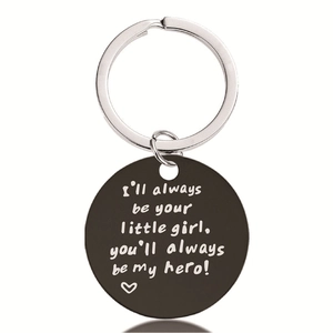Macro shot of black stainless steel round keychain with father-daughter engraving