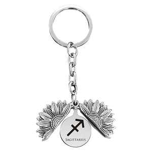 Detail of silver sunflower keychain with rotating petals showing Sagittarius zodiac sign