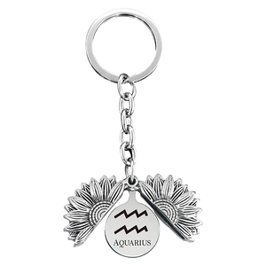 Detail of sunflower locket keychain featuring Aquarius zodiac symbol and engraved name