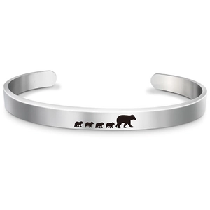 Detailed view of polished stainless steel cuff bracelet with mama bear and cubs engraving
