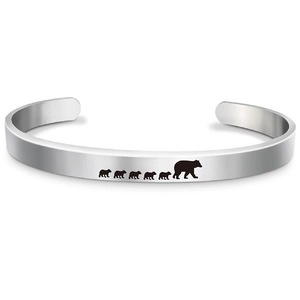 Close-up of polished stainless steel open bangle with Mama Bear and cubs motif
