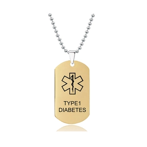 Makroansicht des goldenen medizinischen Anhängers mit Typ-1-Diabetes Gravur und Lebensstern