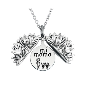 Detailed view of sunflower locket opening to show mi mama engraving and figures