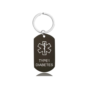 Detail of black matte medical alert keychain showing Type 1 Diabetes text and Star of Life