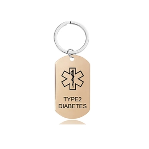 Macro detail of rose gold medical alert keychain showing Type 2 Diabetes engraving