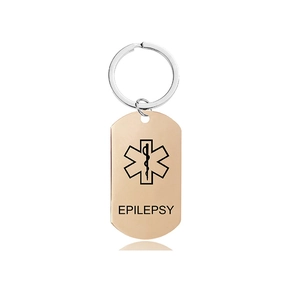 Detailed macro view of rose gold medical alert keychain with engraved Epilepsy label