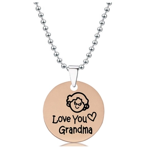 Detail showing rose gold round pendant with Love You Grandma engraving on ball chain