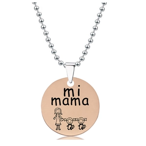 Macro detail of rose gold pendant with mi mama text and cartoon children engraving