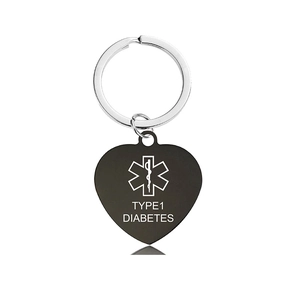 Macro detail of a heart-shaped medical alert keychain for type 1 diabetes in black