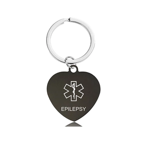 Detail of heart-shaped black medical alert keychain with epilepsy engraving and Star of Life
