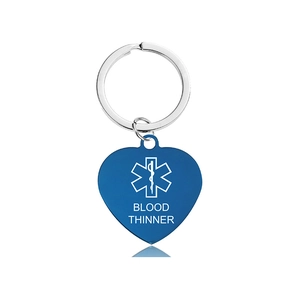 Detail view of heart-shaped medical alert keychain with Star of Life and Blood Thinner text