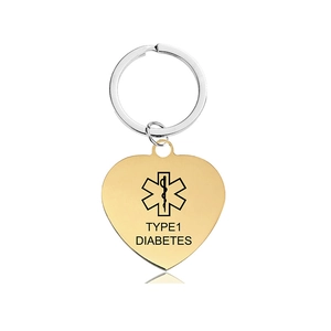 Detail of golden heart medical alert tag with Type 1 Diabetes text and star of life