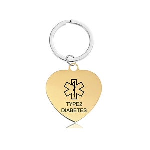 Macro shot of gold heart medical alert tag with Type 2 Diabetes text and Star of Life