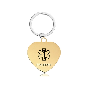 Close-up of gold heart medical alert keychain with Star of Life and Epilepsy engraving