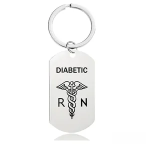 Detail of stainless steel keychain featuring a medical diabetic alert tag and rod of Asclepius