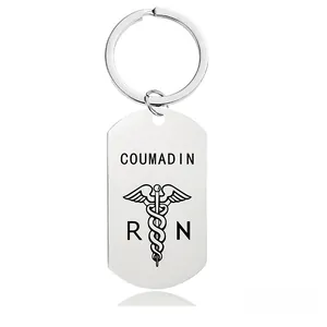 Macro detail of silver medical keychain featuring COUMADIN engraving and the Caduceus symbol