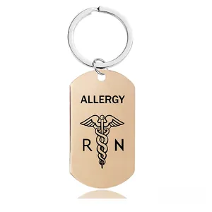 Close-up of golden dog tag keychain with Allergy text, RN lettering, and medical symbol