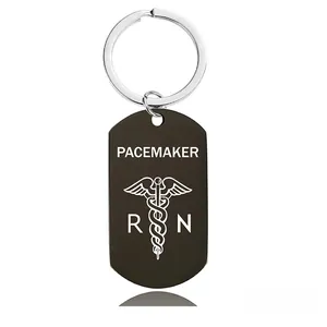 Detail of black metal medical alert keychain with PACEMAKER text and Caduceus symbol