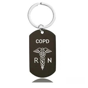 Detail of black medical tag keychain featuring laser-engraved COPD and RN medical symbols