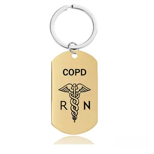 Detailed macro view of the gold COPD medical alert keychain featuring the RN caduceus symbol