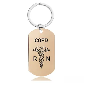 Detailed close-up of rose gold medical alert keychain with COPD and RN engravings