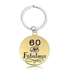 Détail du porte-clés rond en métal avec texte 60 And Fabulous pour anniversaire