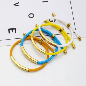 Close-up of colorful woven rope bracelets with polished gold-plated stainless steel plates