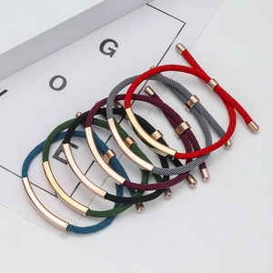 Detailed view of colorful woven adjustable bracelets with rose gold curved metal tubes