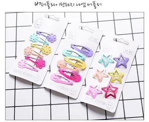 Detail of candy-colored flower and star hair clips set on a white display card