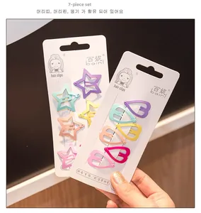 Macro detail of star and heart shaped colorful metal hair clips set for children