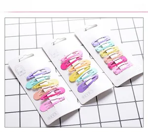 Detailed view of macaron color hair clips in various geometric shapes on a card