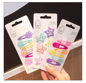 Detailed macro view of colorful macaron hair clip set on white cardboard packaging