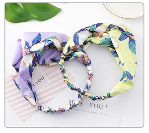 Detail of wide crossover headbands featuring lemon leaf floral prints and elastic bands