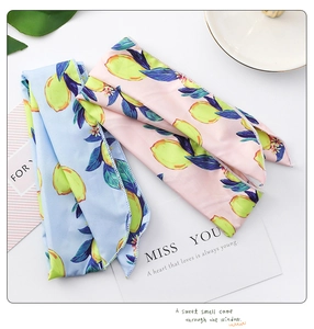 Close-up of lemon print hair bands in blue and pink with smooth silky texture detail