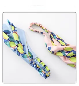 Detail of light blue and pink headbands with lemon print and elastic back design