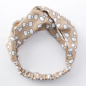 Minimalistisches khakifarbenes Knoten-Stirnband mit weiß-schwarzem Schleifenmuster