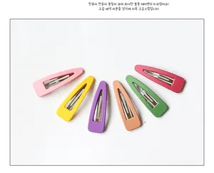 Detail view of colorful matte BB hair clips in pink, yellow, purple and green hues