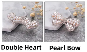 Detailed view of hair clips with double heart and pearl butterfly rhinestone designs