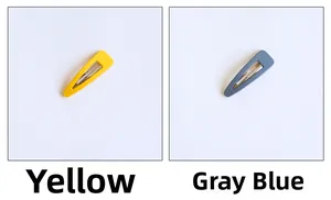 Close-up of yellow and grey-blue matte teardrop BB hair clips with silver metal base