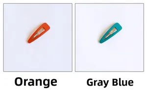 Macro detail of matte metal water drop BB hair clips in vibrant orange and gray blue colors