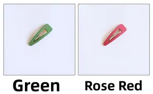 Detail view of matte green and rose red snap hair clips with a smooth frosted finish