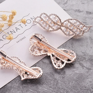 Elegant gold hair clips set with pearls and rhinestones in butterfly and wing designs