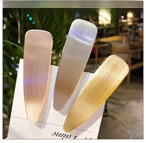 Lot de trois barrettes en métal doré, argenté et cuivre avec finition mate brossée