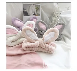 Detail view of plush bunny ear headbands in four pastel colors including pink and white