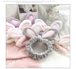Macro shot of plush bunny ear headbands in grey, pink, purple and white coral fleece