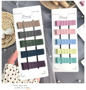 Detail view of 5-piece Morandi matte bobby pins set on a display card for girls
