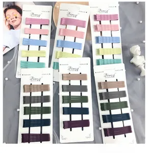 Detail of colorful matte metal bobby pins set neatly arranged on a display card