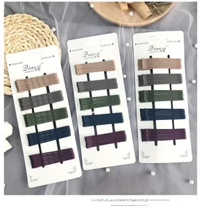 Macro shot of matte candy-colored bobby pins neatly arranged on cards for daily hair styling